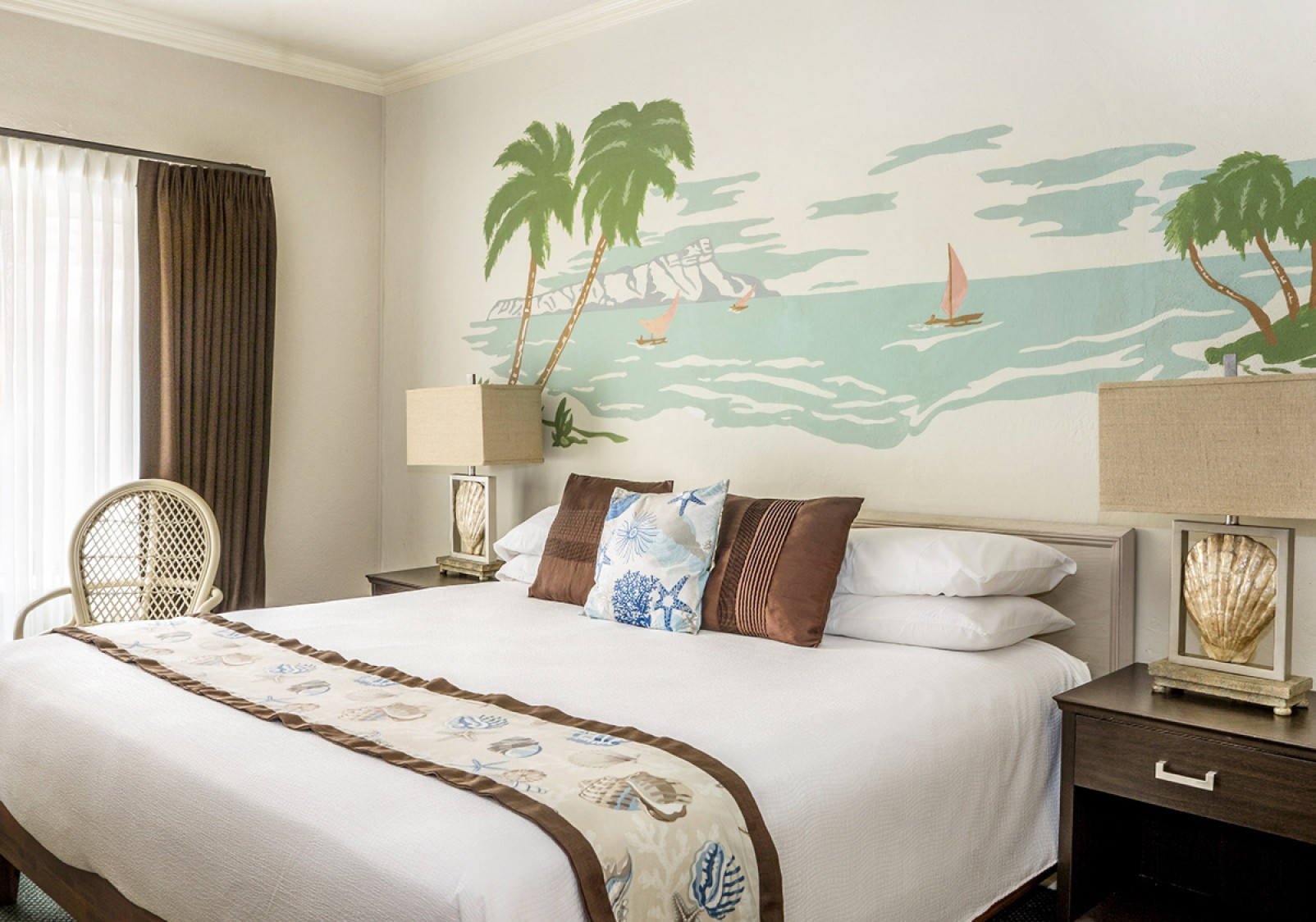 a bed with pillows and a painting on the wall