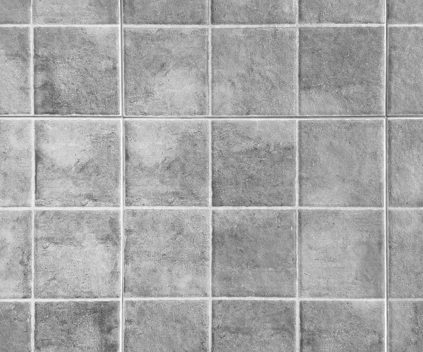 a grey tile floor with square tiles