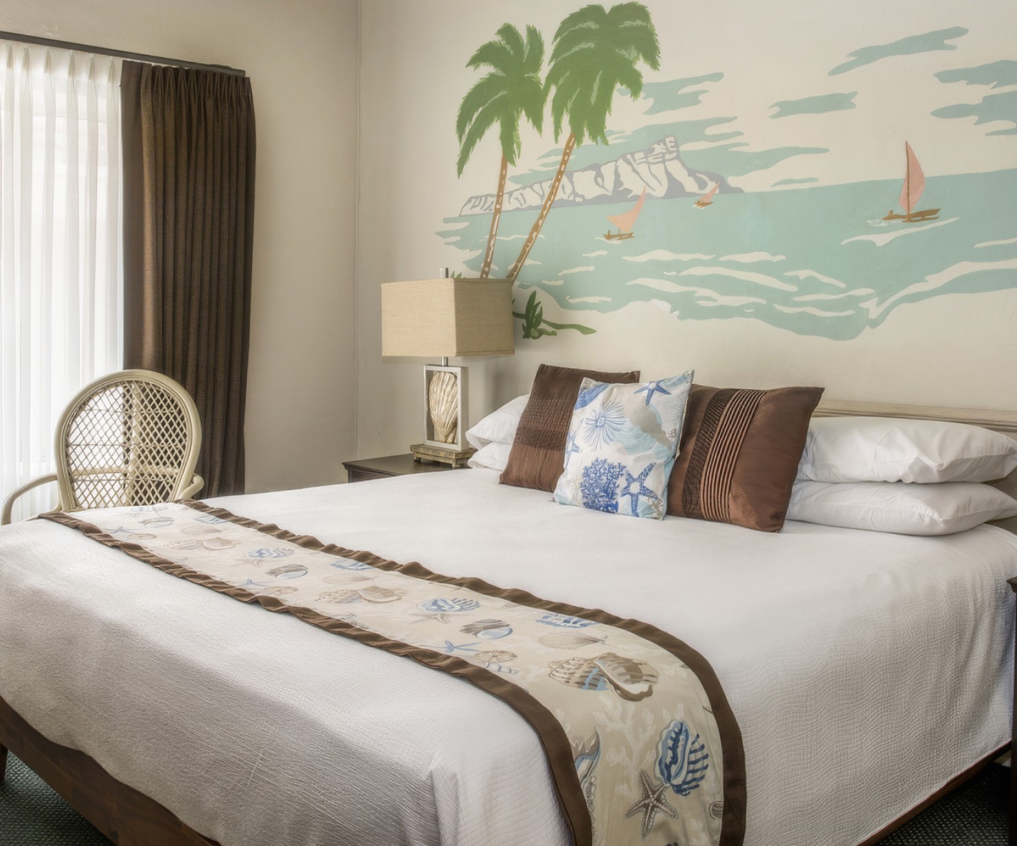 a bed with a lamp and a painting on the wall