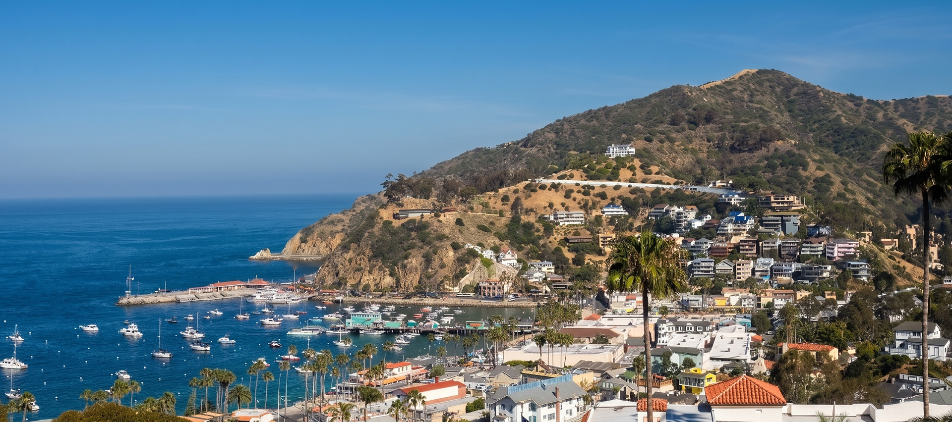 a town on a hill with boats in the water