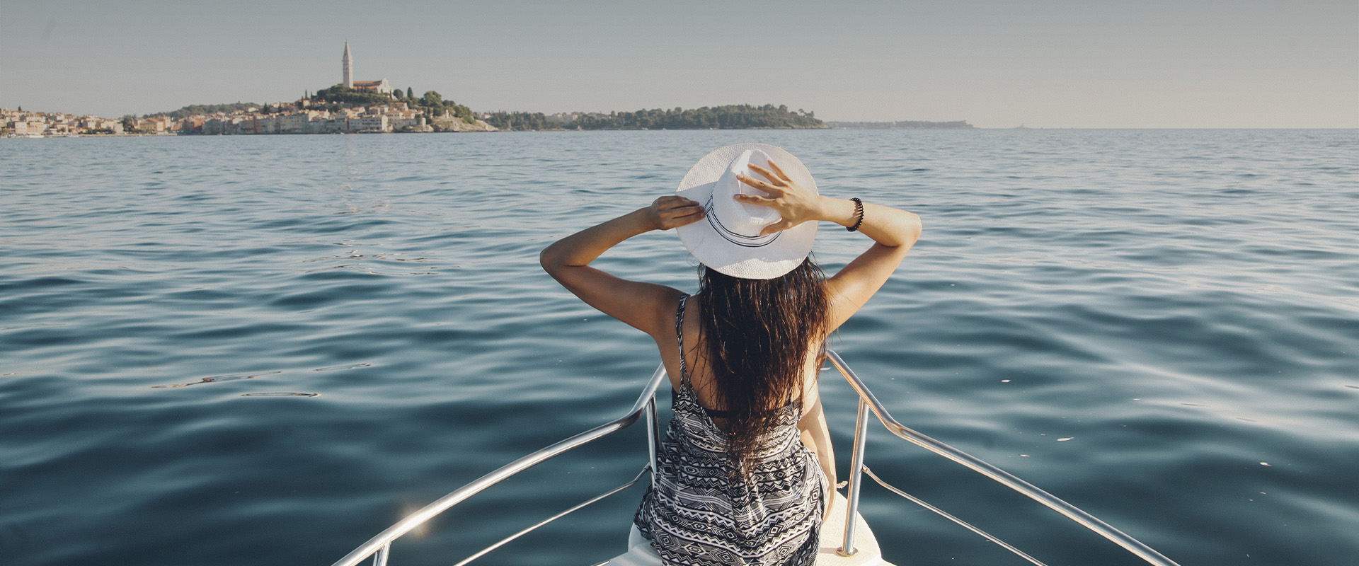 a woman in a hat on a boat