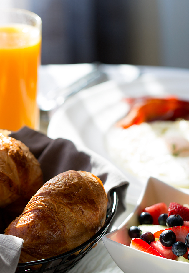 a breakfast with croissants and fruit