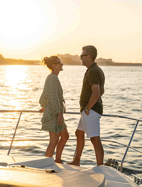 a man and woman standing on a boat