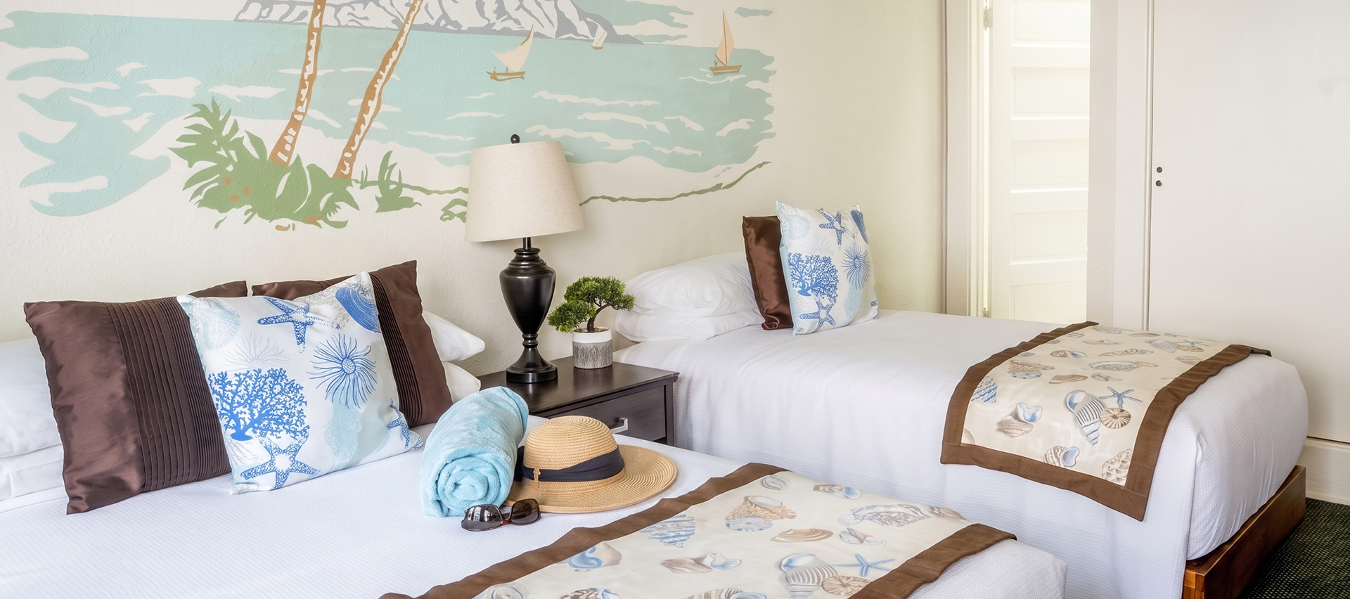 a bed with a hat and sunglasses on it