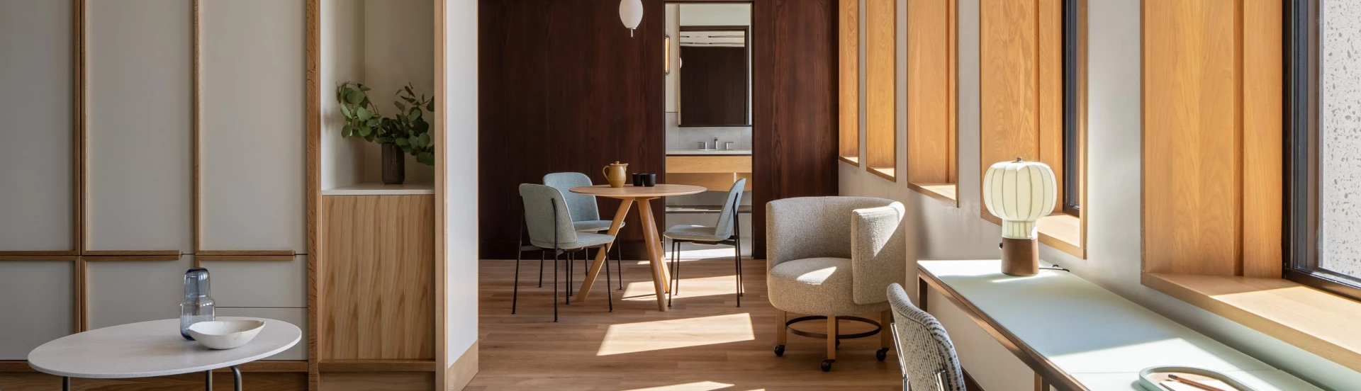 a room with a table chairs and a mirror