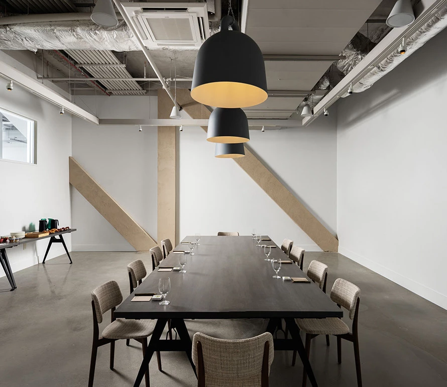 a meeting room with a long table and chairs