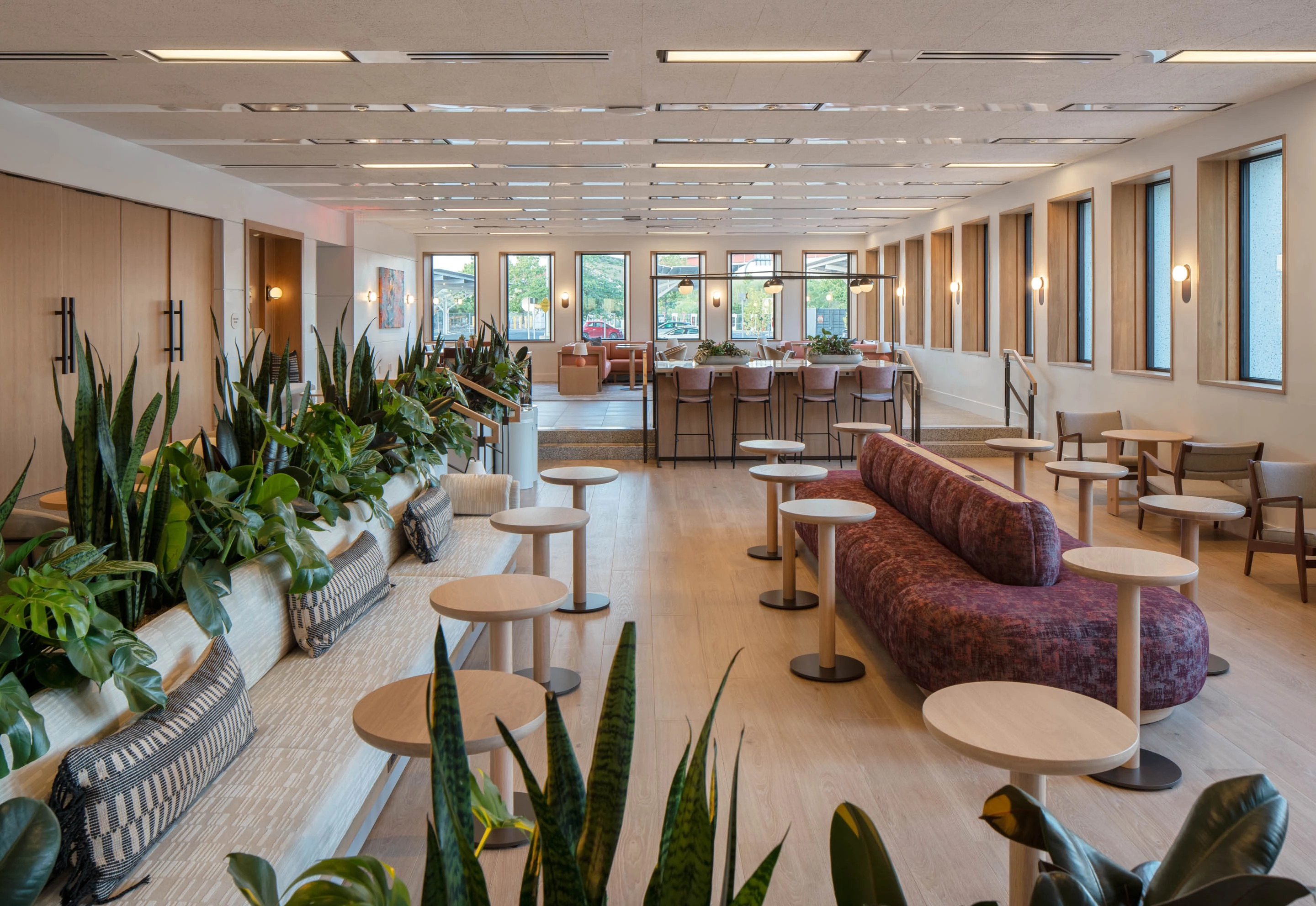 a room with tables and chairs and tables and plants