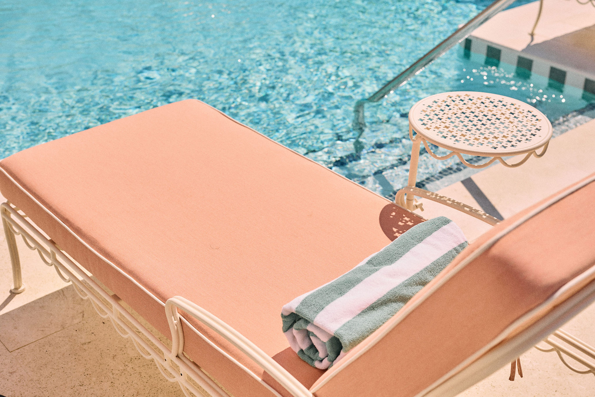 a pool with a pink bed and a towel