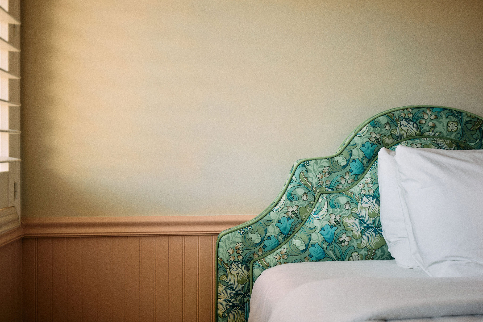 a bed with a floral headboard