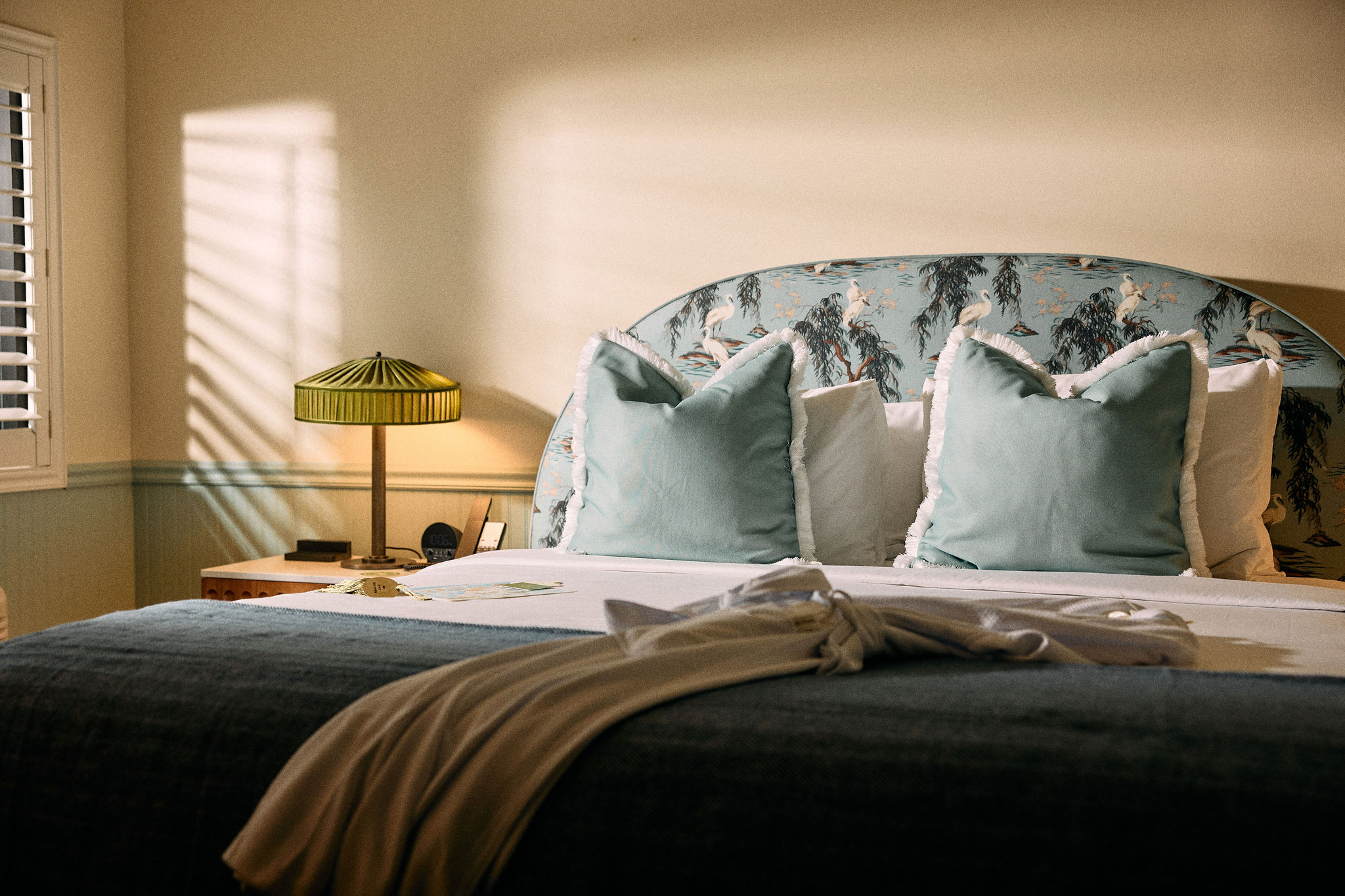 a bed with pillows and a lamp