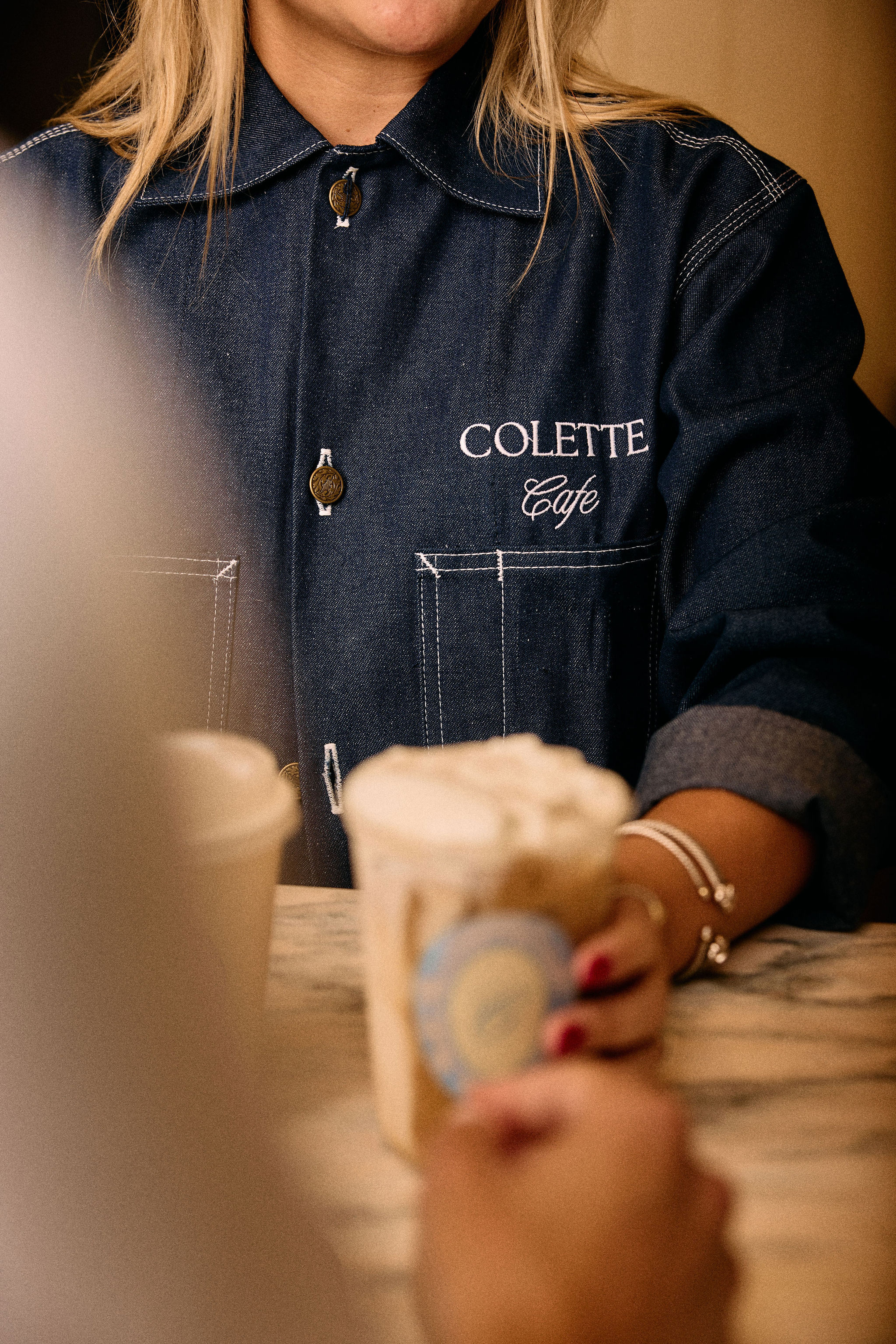 a woman holding a cup of coffee