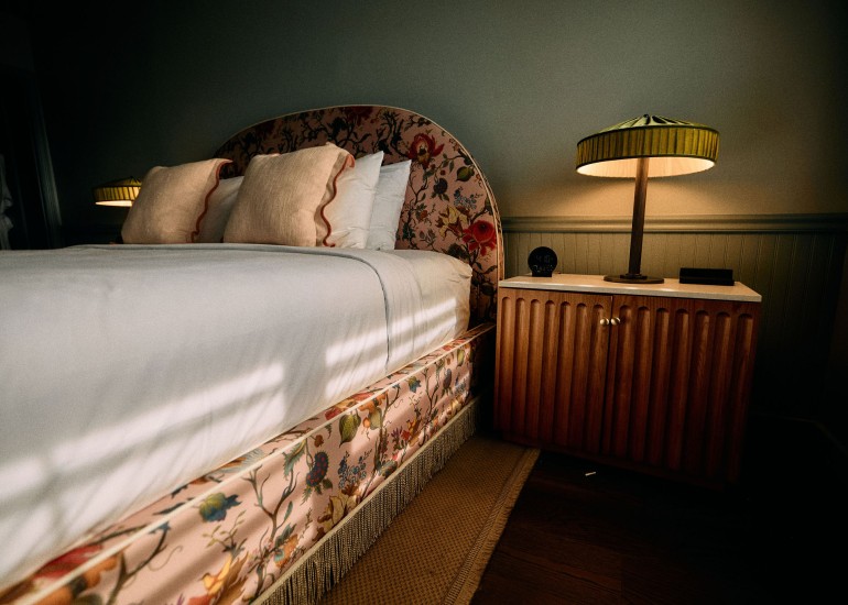 a bed with a lamp next to it