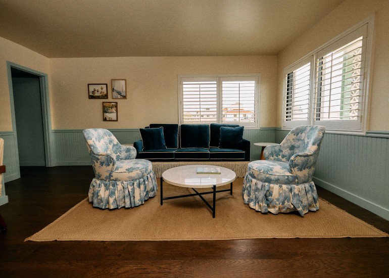 a living room with a couch and chairs