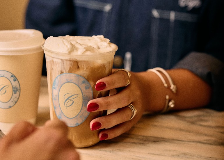 a person holding a cup of coffee