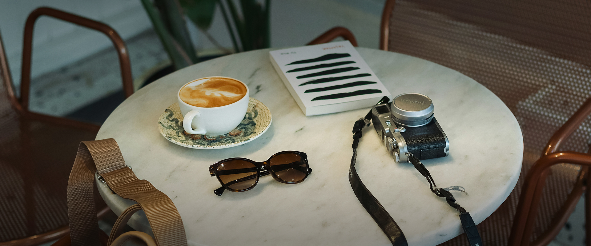 a coffee cup and sunglasses on a table