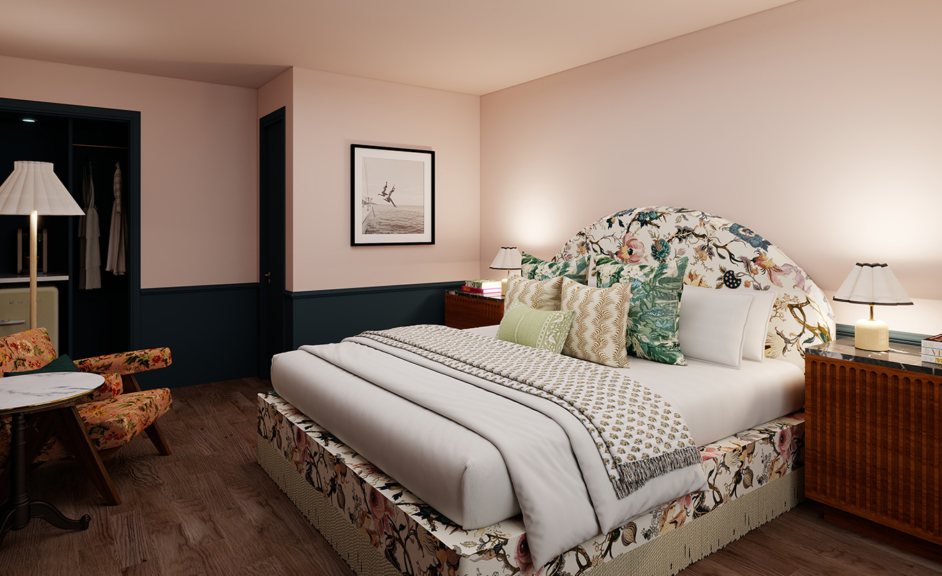 a bed with floral bedding and a picture on the wall