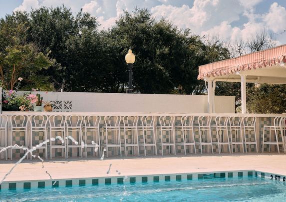 a pool with chairs and a fountain