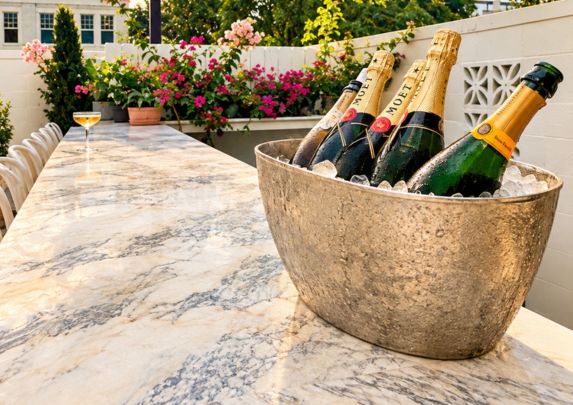 a bucket of champagne on a marble table
