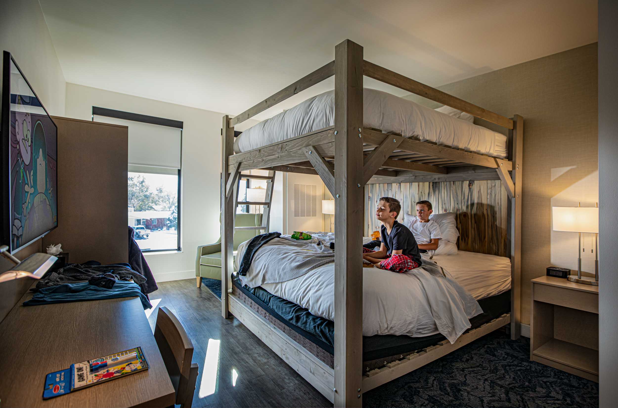 a group of people sitting on a bunk bed