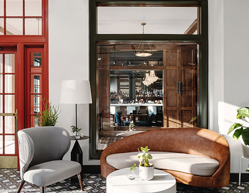a room with a couch and chairs