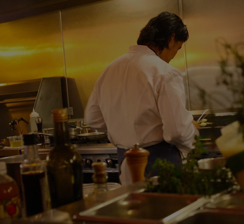A chef cooking in a kitchen.