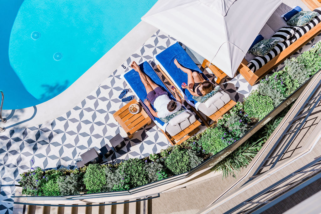 birds eye view pool couple relaxing