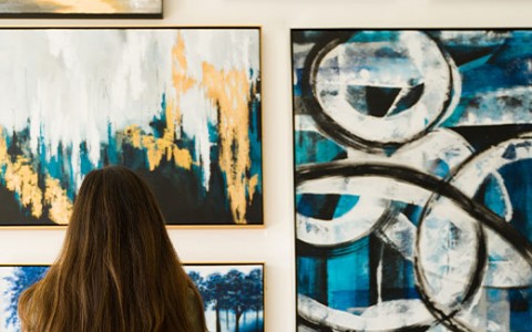 woman looking at an art exhibition