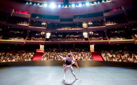 a man and woman performing in a theater