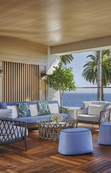 a patio with a couch and chairs