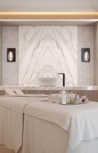 a massage table with towels and a sink