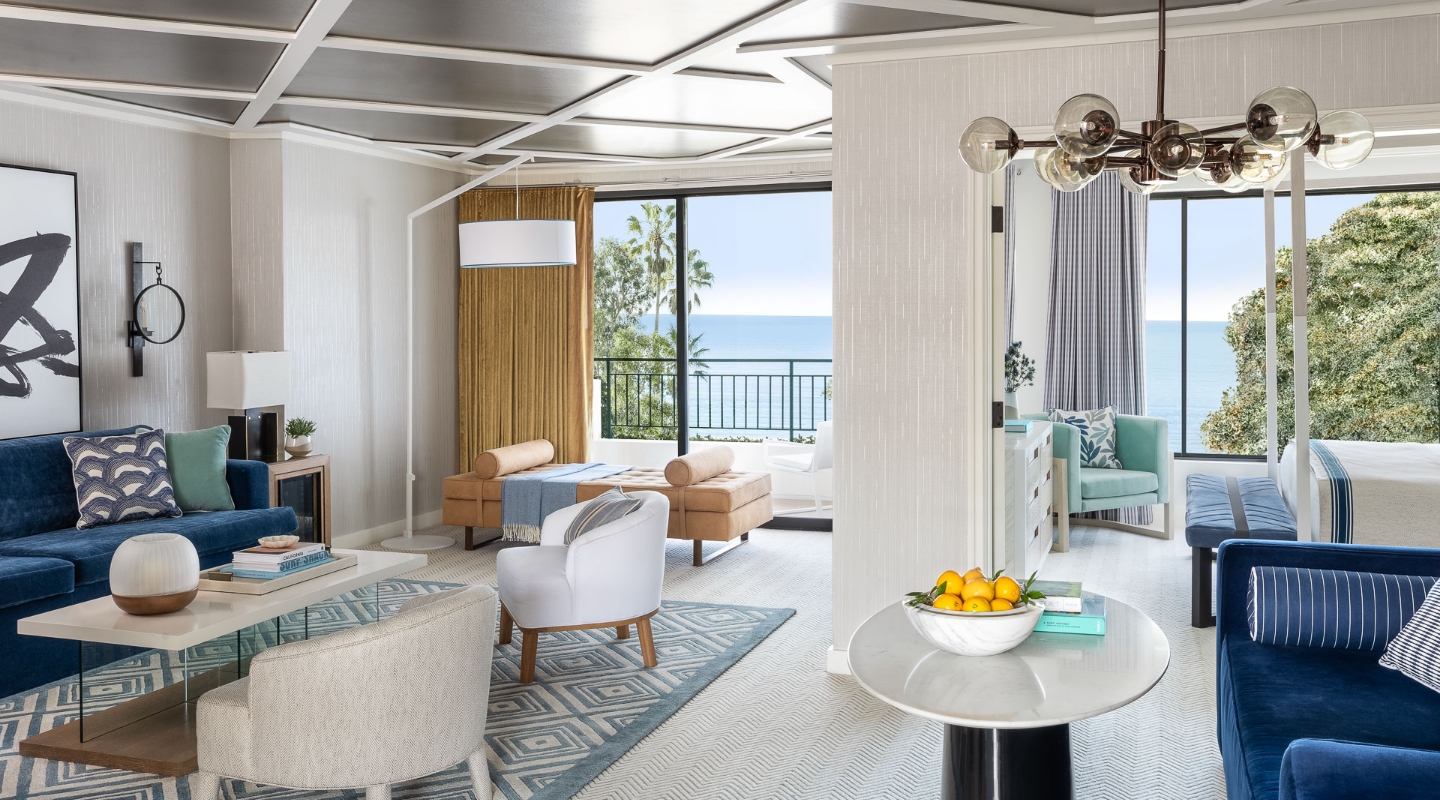 a living room with a view of the ocean