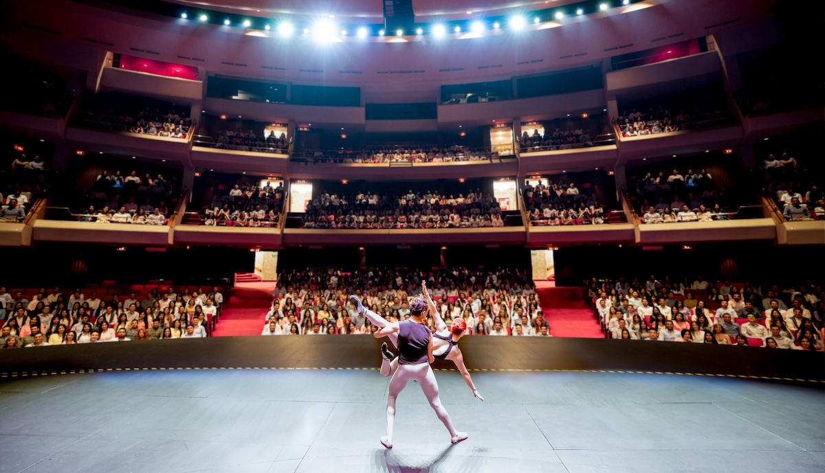a man and woman performing in a theater