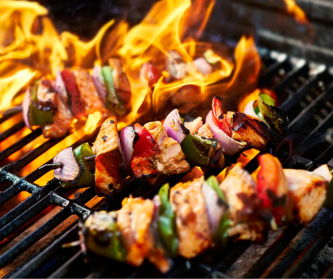 food on skewers on a grill