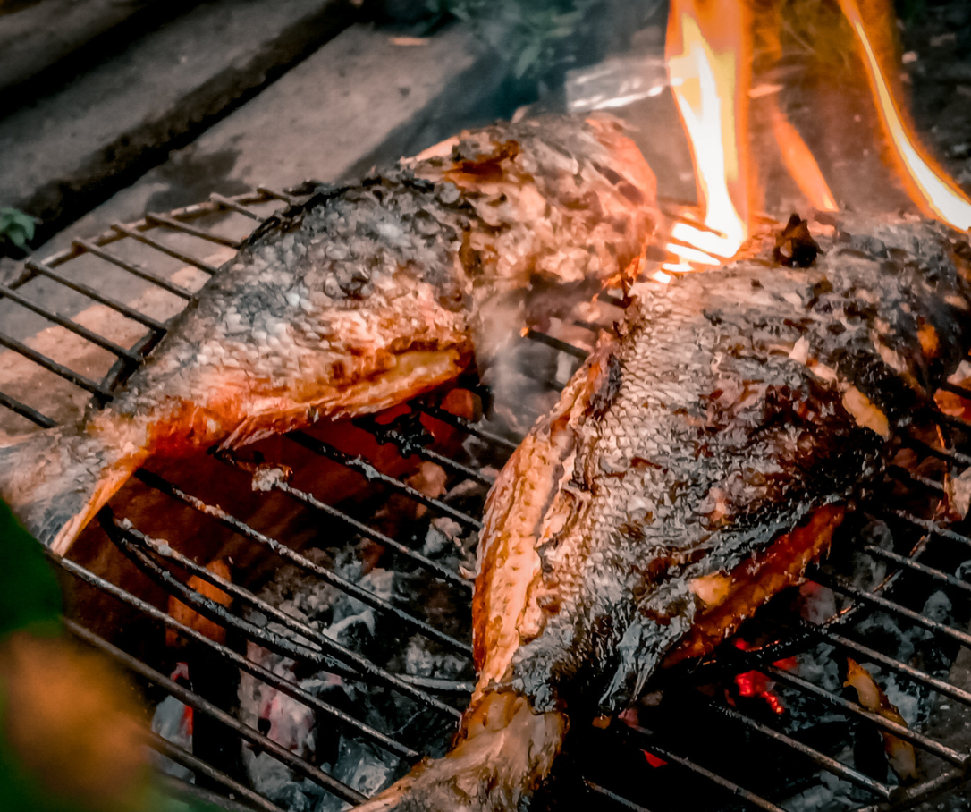 fish on a grill with flames
