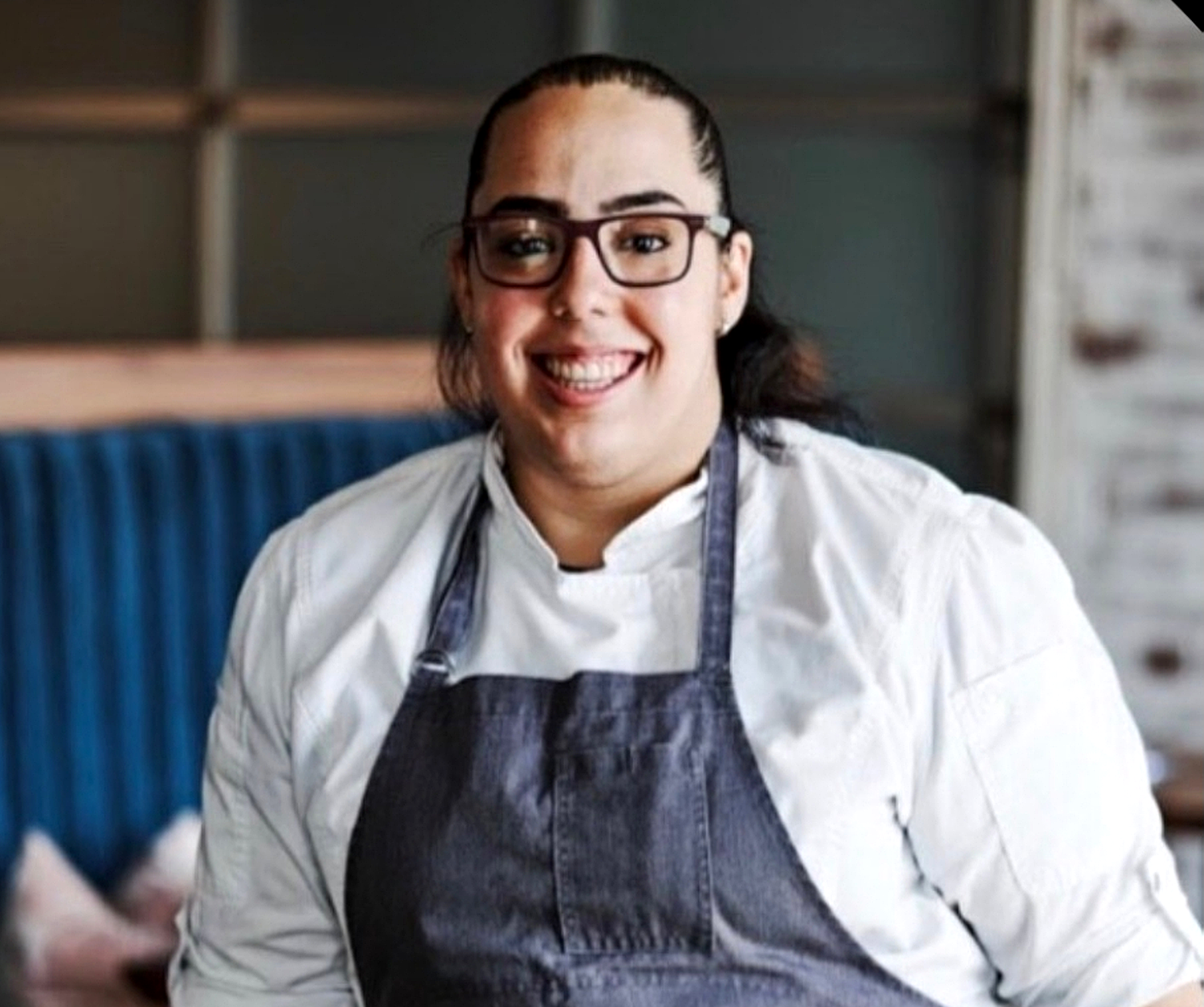 a woman wearing glasses and a apron