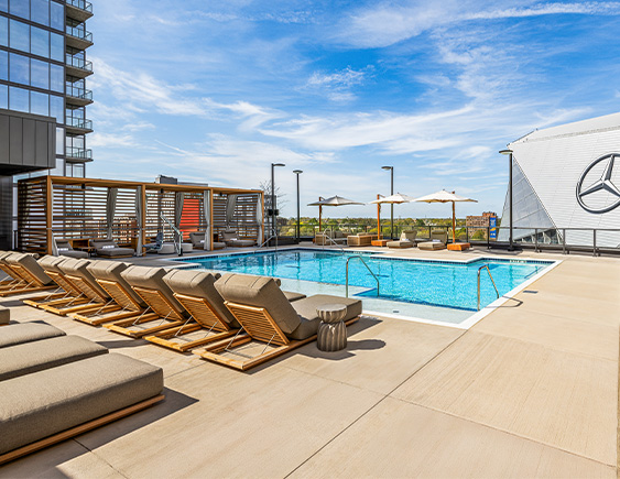 a pool with lounge chairs and umbrellas