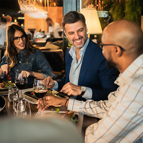 a group of people sitting at a table eating food