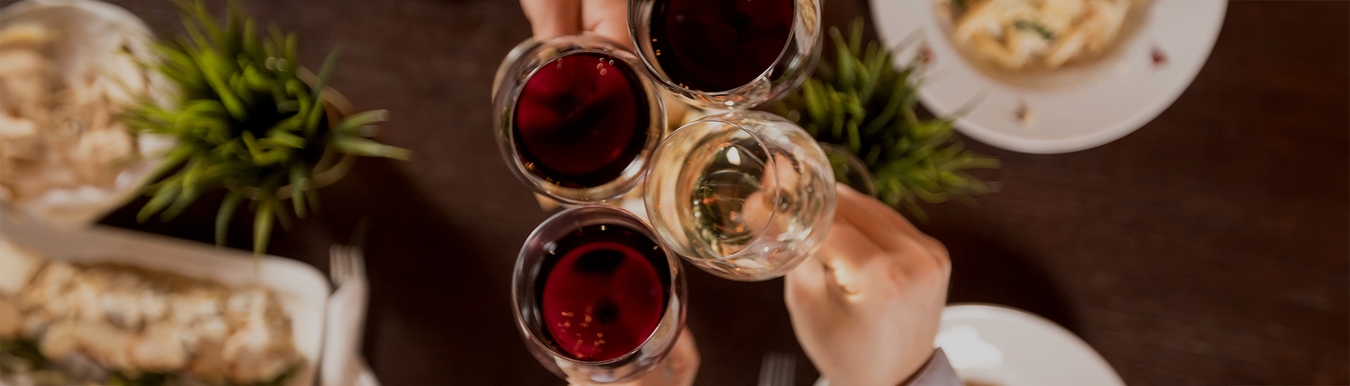 a group of hands holding wine glasses