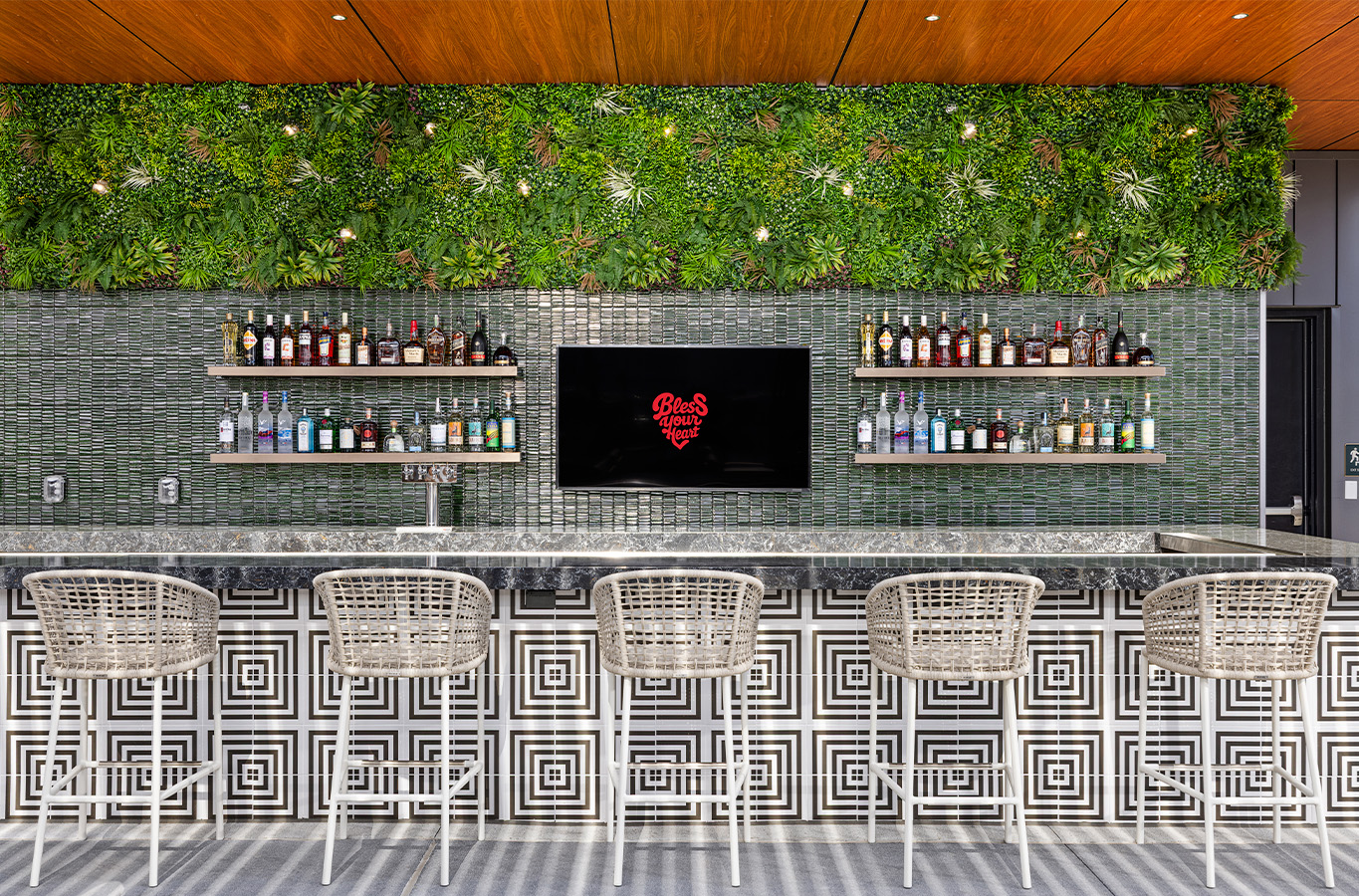a bar with a tv and shelves of liquor