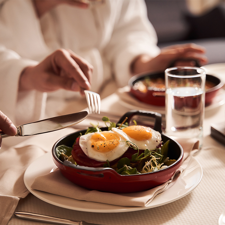 a person eating food with a fork and knife