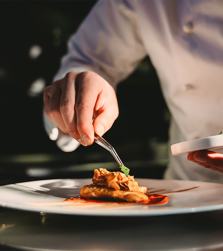 a person holding a plate of food