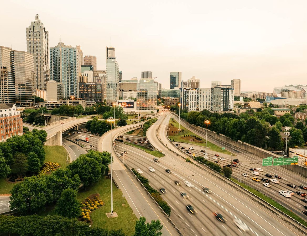 a highway with cars and trees in the background