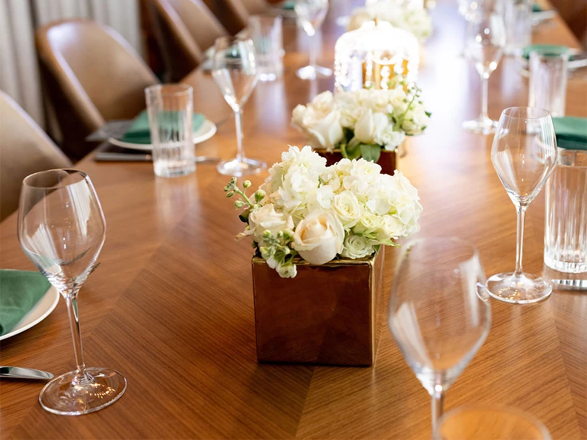 a table with glasses and flowers