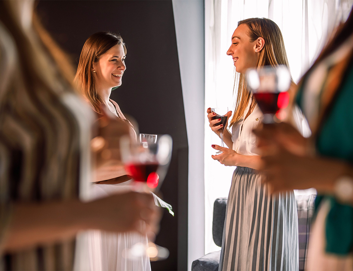 a group of women holding wine glasses