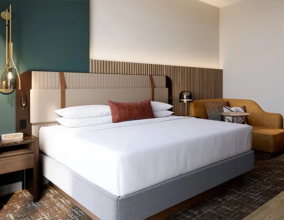 a bed with a headboard and a lamp