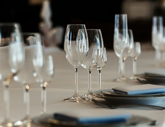 a table with empty wine glasses