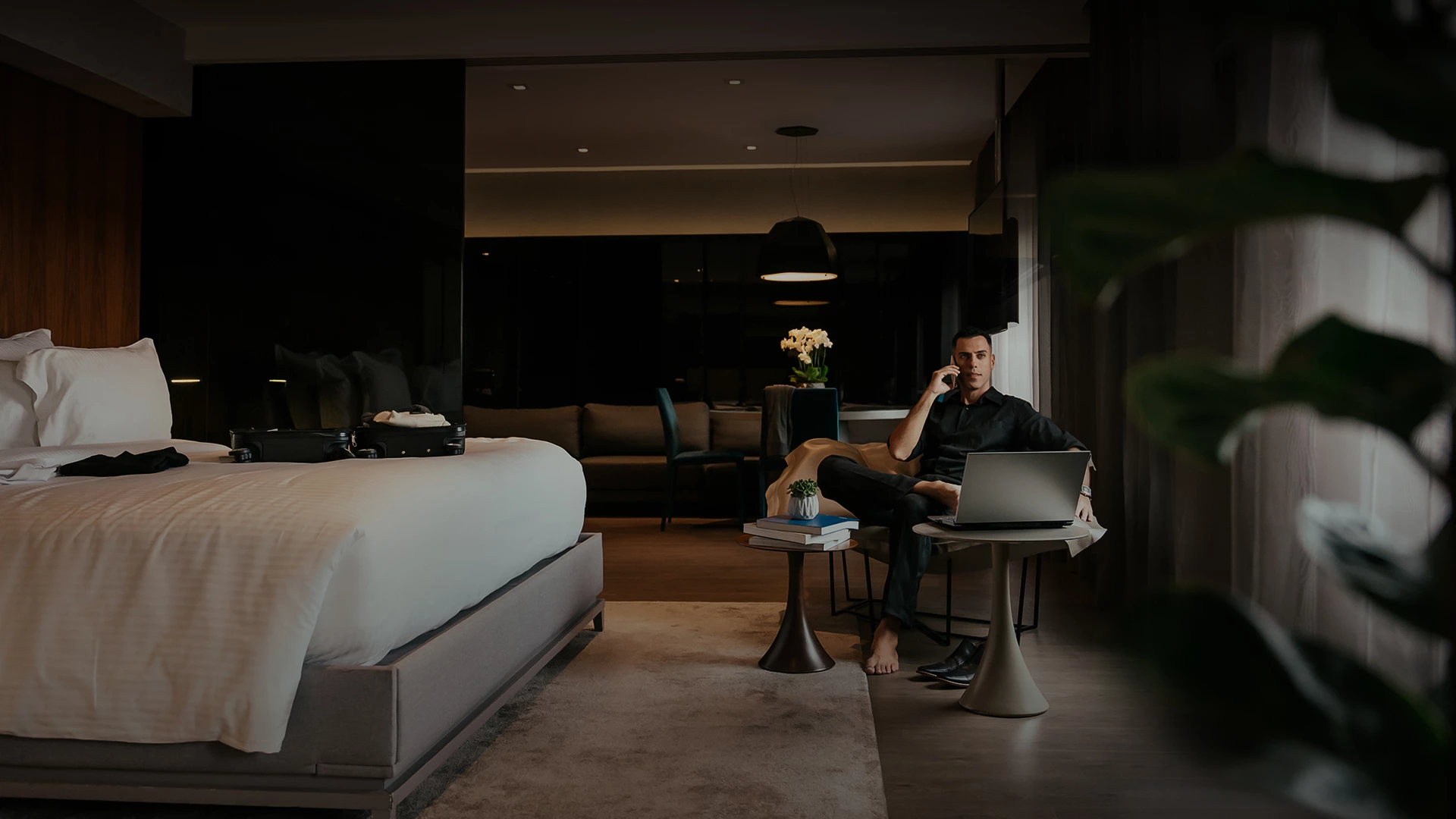 a man sitting on a table in a hotel room