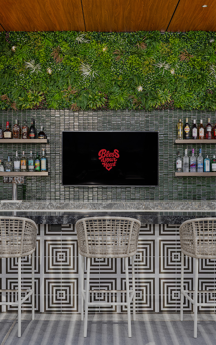 a bar with a tv and shelves of liquor