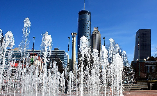 a water fountain in front of a city