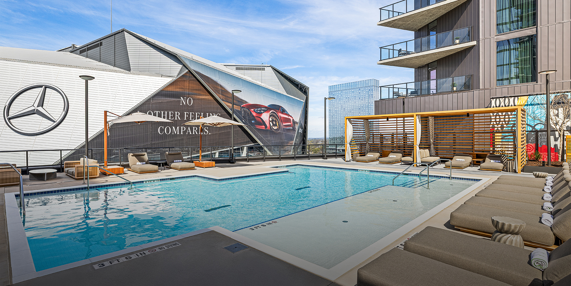 a swimming pool with lounge chairs and umbrellas in a building